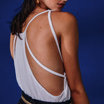 Model wears a white open back t shirt
