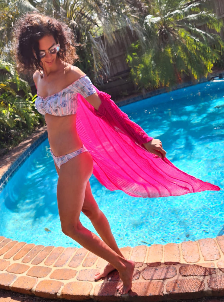 model wears light pink bikini with pink long sleeves knitting beach cover