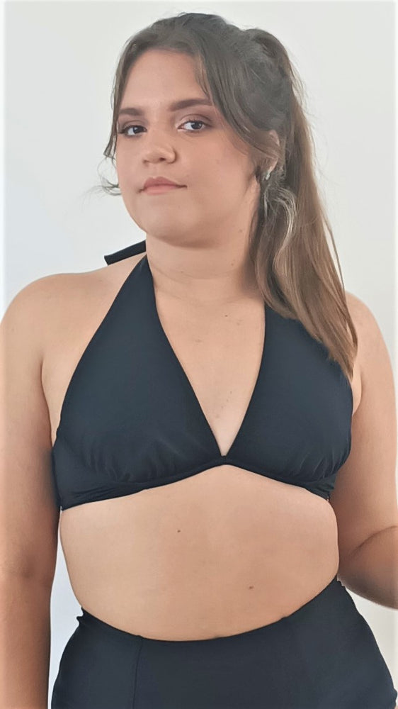 
                  
                    model wears halter bikini top with high waisted bikini bottom. all in black
                  
                