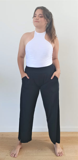 
                  
                    model wears black pantaloon pants with white top.
                  
                