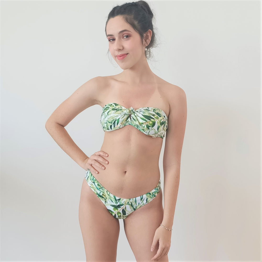 model wears strapless bikini top with Brazilian style bottom