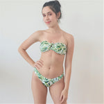 model wears strapless bikini top with Brazilian style bottom