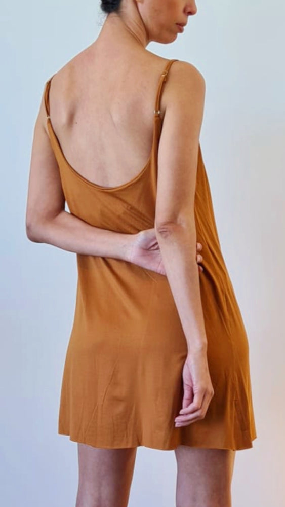 model wears earthy colour short dress with adjustable stripe.