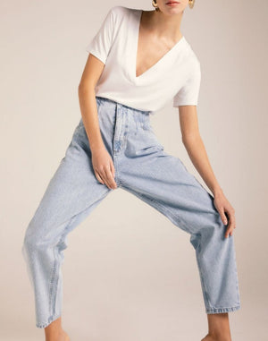 
                  
                    Model wears a basic white t-shirt and mom's jeans, in very light blue
                  
                